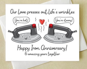 May include: A white greeting card with the text "Our Love presses out life's wrinkles" and "Happy Iron Anniversary!" features two cartoon irons with speech bubbles saying "You're hot!" and "You're steamy!"