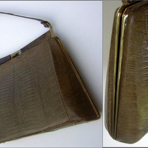 May include: A brown leather handbag with a gold clasp and a gold chain strap. The bag has a textured, embossed pattern.