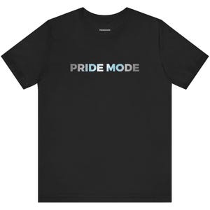 May include: Black t-shirt with the text "PRIDE MODE" in a gradient of blue, light blue, and white.