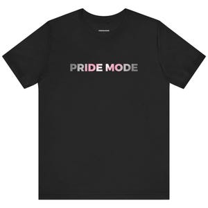 May include: Black t-shirt with the text "PRIDE MODE" in pink and white gradient lettering.