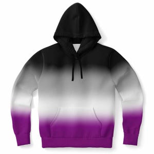 May include: A hooded sweatshirt with a color gradient design. The top of the hoodie is black, transitioning to gray, then white, and finally, a deep purple at the bottom. It features a front pocket and a drawstring hood.