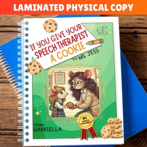 May include: A laminated physical copy of a spiral-bound book with the title "If You Give Your Speech Therapist A Cookie." The cover features illustrations of mice, cookies, and text. The book is on top of blue and white notebooks.