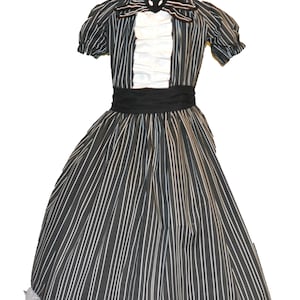 May include: A black and white striped dress with a white ruffled front panel, short sleeves, and a black waist sash. The dress features a decorative black cat-shaped bow tie and a white lace hemline. The dress is displayed on a mannequin.