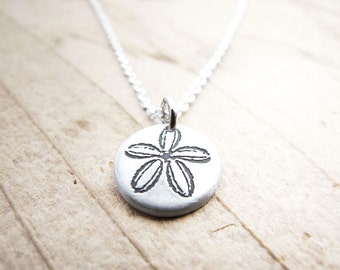 Tiny sand dollar necklace in silver