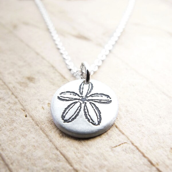 Tiny sand dollar necklace in silver
