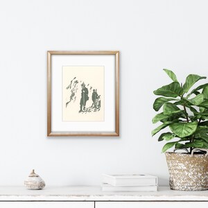 May include: A framed print of a black and white illustration of two figures walking in a mountainous landscape. The figures are silhouetted against a white background.