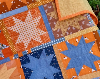 Puppy dog baby / toddler quilt with stars in bright orange, blue and caramel colors, all cotton, machine washable.