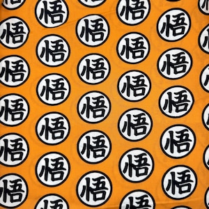 May include: Orange fabric with a repeating pattern of white circles containing the Japanese character "悟" (悟) in black.