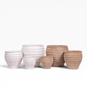 May include: A collection of six terracotta planters in varying sizes, arranged in a group. Three planters are finished in a matte white, while the other three feature a natural earthy brown tone. Each pot has a ribbed, horizontal texture.