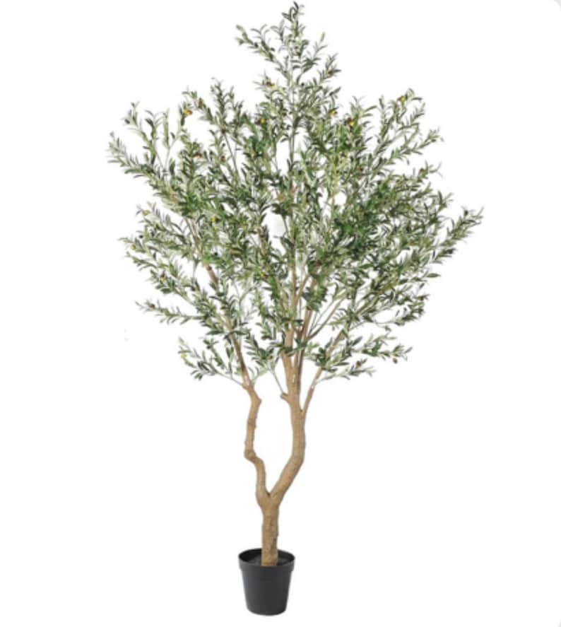 May include: An artificial olive tree with a textured light brown trunk that splits into two main stems. The branches are filled with numerous narrow, pointed green leaves and small, round green and dark-colored olives, all set in a black pot.