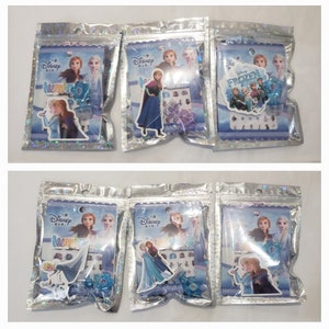 May include: Six individual packages of Frozen nail stickers. Each package features a different design with characters from the Disney movie Frozen. The packages are silver with a holographic finish.
