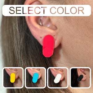 May include: A close-up of a person's ear wearing a red, geometric earring. The image includes a selection of earrings in yellow, blue, white, and black. The text "SELECT COLOR" is displayed above the ear.