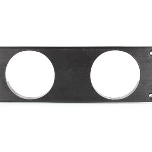 May include: Black plastic panel with two round cutouts for gauges. The panel has four screw holes on the edges.