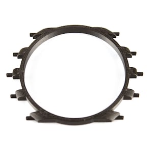 May include: A black plastic watch band ring with a circular shape and multiple small teeth around the edge.