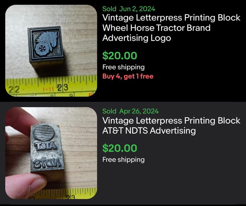 May include: Two vintage letterpress printing blocks. One block features a Wheel Horse Tractor Brand advertising logo. The other block features an AT&T NDTS advertising logo. Both blocks are made of metal and are rectangular.