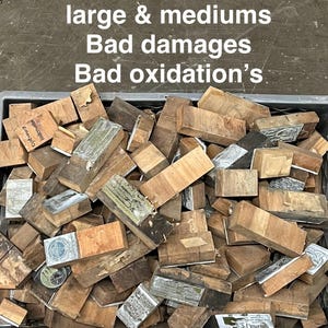 May include: A bin filled with approximately 400 wooden blocks, many with metal plates attached. The blocks vary in size and show signs of damage and oxidation. Text on the image reads "400 Pieces all mainly large & mediums Bad damages Bad oxidation's."