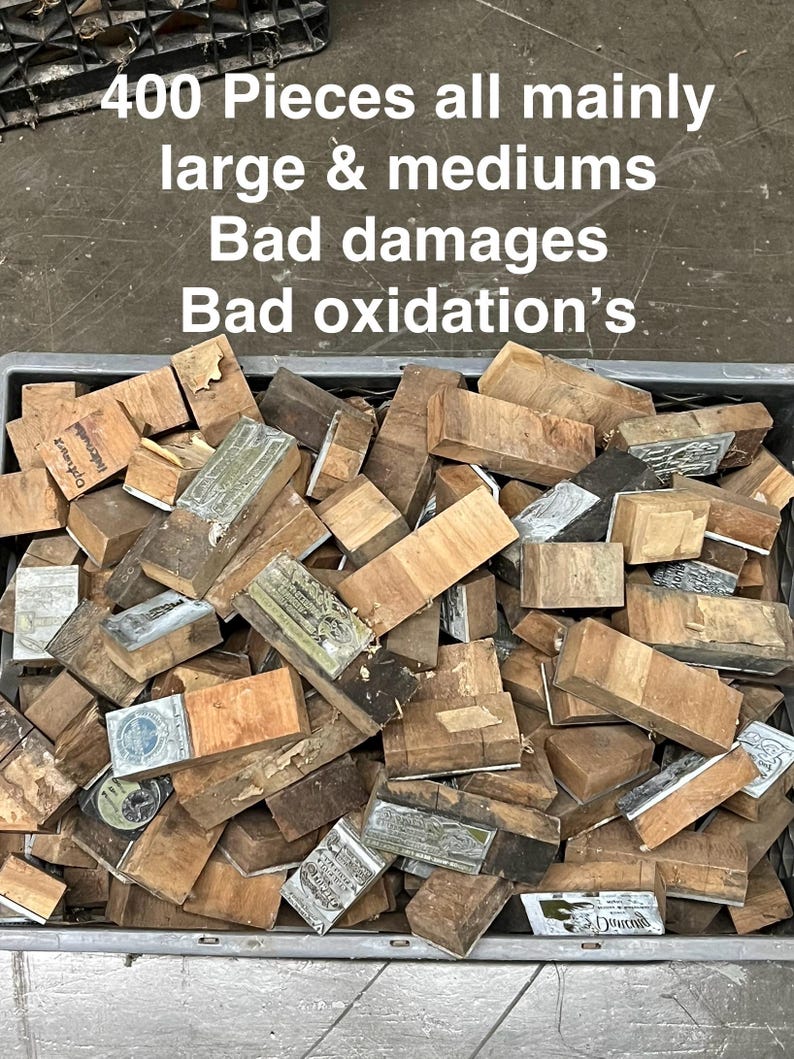May include: A bin filled with approximately 400 wooden blocks, many with metal plates attached. The blocks vary in size and show signs of damage and oxidation. Text on the image reads "400 Pieces all mainly large & mediums Bad damages Bad oxidation's."