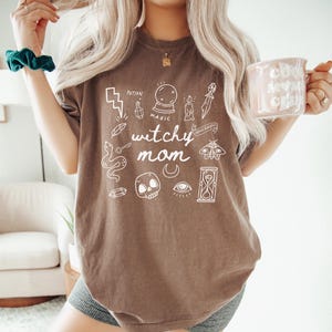 a woman with long blonde hair holding a coffee mug