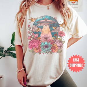 a woman wearing a t - shirt with a picture of a mushroom on it