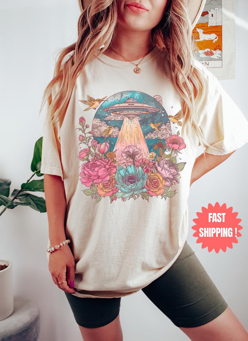 a woman wearing a t - shirt with a picture of a mushroom on it