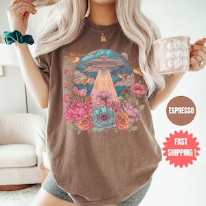 a woman is holding a glass of coffee