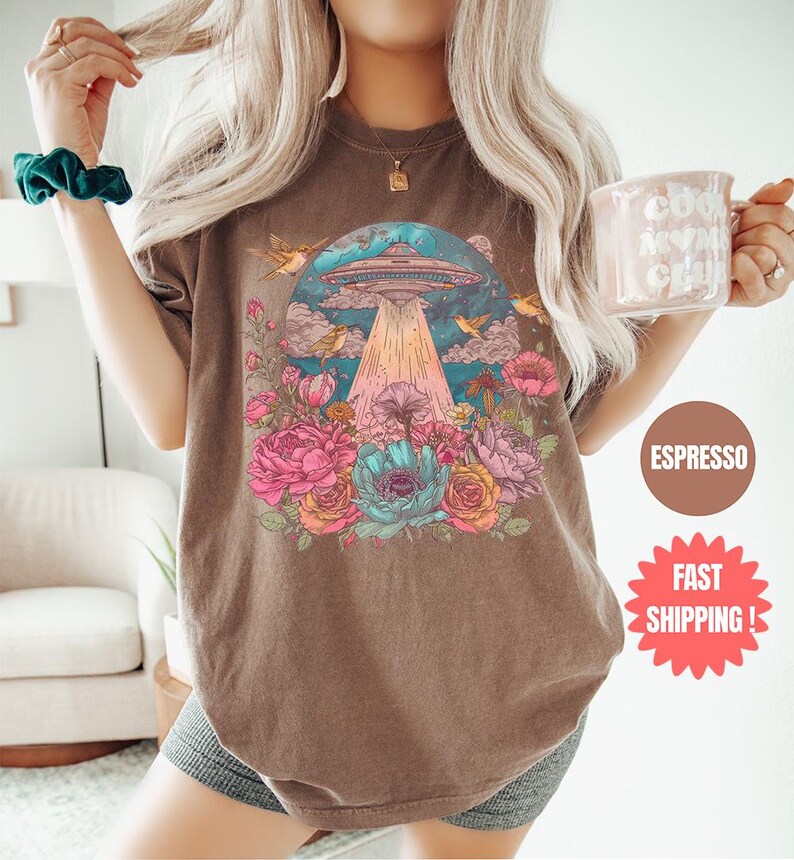 a woman is holding a glass of coffee