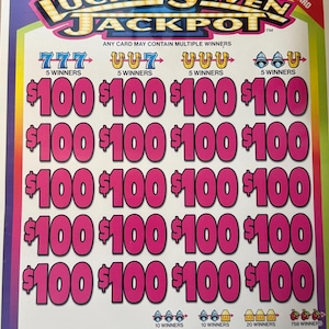 May include: A colorful "Lucky Seven Jackpot" scratch-off ticket. The ticket features the text "Lucky Seven Jackpot" in a vibrant design. The ticket displays multiple winning combinations and prize amounts, including $100 and other amounts.