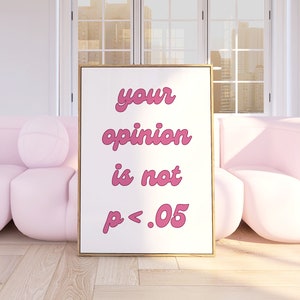 May include: A framed poster with a pink background and the text "your opinion is not p < .05" in pink cursive font. The poster is hanging on a white wall between two pink armchairs.