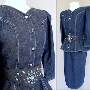 May include: This denim peplum suit is vintage 1980's.  
The jacket has a wide V neckline, silver buttons up the front, puffy 3/4 length sleeves with a single button cuff, and a super flared hemline to create a peplum.  Accented with white topstitching. 

The rigid, obi style belt has faux turquoise  and silver studs.

The unlined  pencil skirt has a slit in the back for wearing ease and a back zipper.