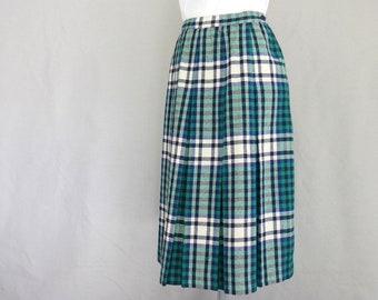 May include: A pleated skirt with a green, white, and black plaid pattern.