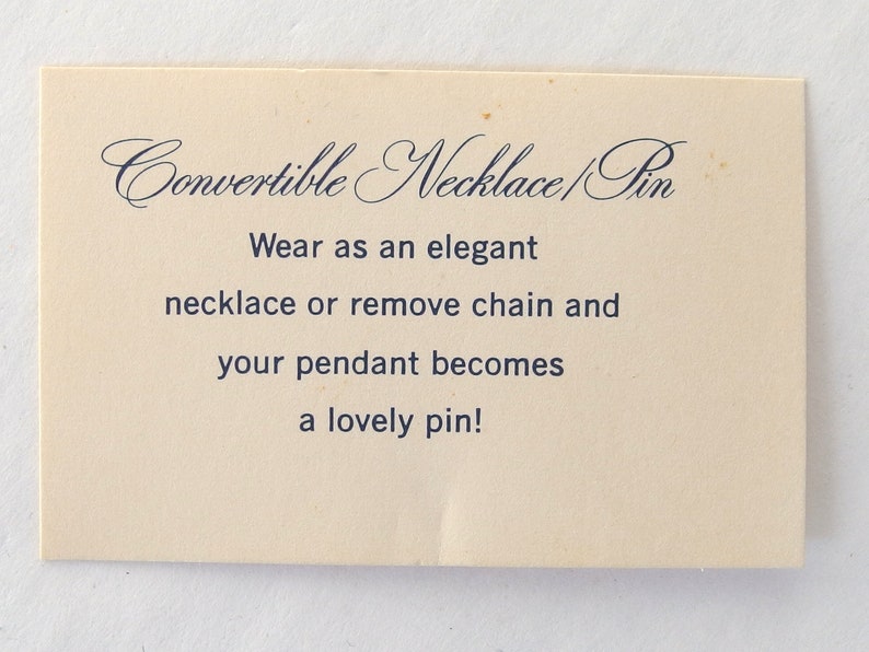 Note reads:  "Convertible Necklace Pin, wear as an elegant necklace or remove chain and your pendant becomes a lovely pin!"