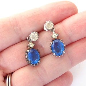 vintage Avon blue crystal glass set includes a necklace whose pendant may be used as a brooch, an adjusting ring, and a pair of dangle post earrings.