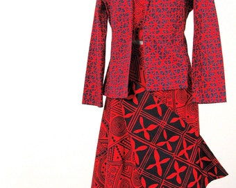 May include: A red and blue patterned blazer and skirt set. The blazer has a geometric pattern and the skirt has a more abstract pattern with black and red accents.