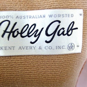 May include: A white label with black text that reads "100% Australian Worsted Holly Gab Kent Avery & Co., Inc.".