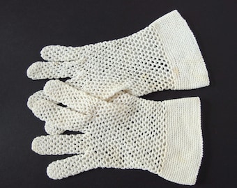 May include: A pair of white crocheted gloves with a delicate, open-weave pattern. The gloves have a simple, elegant design and are perfect for adding a touch of vintage charm to any outfit.