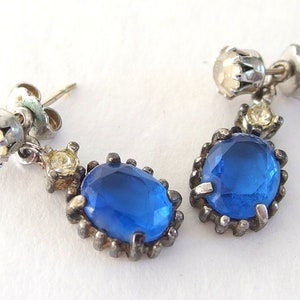 vintage Avon blue crystal glass set includes a necklace whose pendant may be used as a brooch, an adjusting ring, and a pair of dangle post earrings.