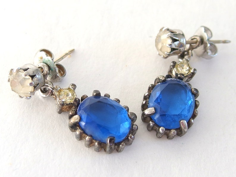vintage Avon blue crystal glass set includes a necklace whose pendant may be used as a brooch, an adjusting ring, and a pair of dangle post earrings.