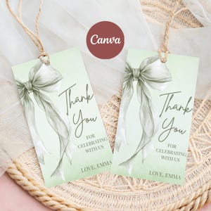 Puede incluir: Dos etiquetas de regalo rectangulares con un diseño de lazo de acuarela y las palabras "Thank You" en escritura elegante. Las etiquetas también incluyen el texto "For Celebrating With Us" y "Love, Emma."