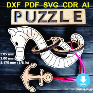 May include: Wooden puzzle with a seahorse and anchor design. The word "PUZZLE" is carved into a wooden block. The image includes the text "DXF PDF SVG CDR AI" and "DIGITAL FILE". The seahorse puzzle measures 3.175 mm (1/8 in).