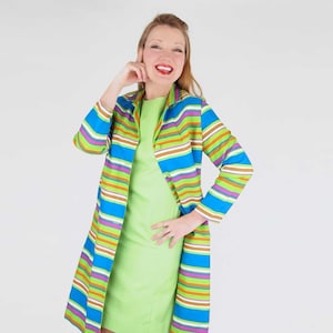 May include: A lime green sleeveless dress paired with a matching long-sleeved coat featuring horizontal stripes in shades of blue, lime green, white, and brown. The coat has a collar and a button-front closure, while the dress has a simple neckline.