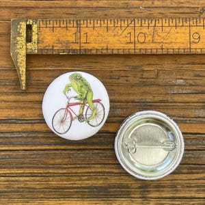 Frog Riding Bicycle Button Pin | Illustrated Nature Animal Art, Soft-Touch Matte Finish