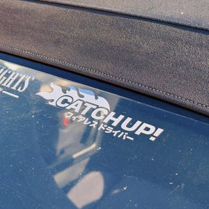 May include: A silver sticker with the text "Catchup!" and a flame design. The text "ワイヤレスドライバ" is written in Japanese below the logo.