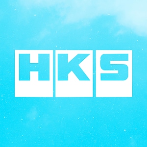 May include: White HKS logo on a light blue background. The letters H, K, and S are in a bold, sans-serif font, each within a white rectangular frame. The background has a gradient effect, suggesting a sky.