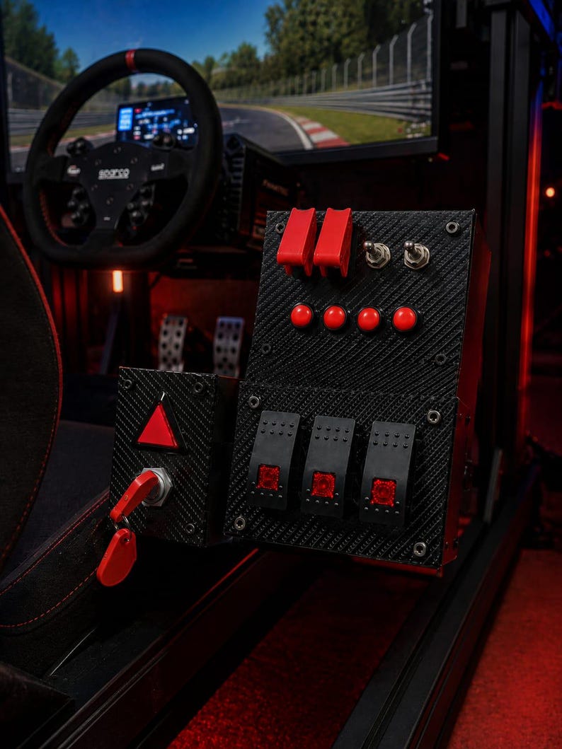 May include: A black carbon fiber textured button box for racing simulators featuring two red flip switches with safety covers, two metal toggle switches, four round red push buttons, three rectangular red illuminated rocker switches, and a red ignition key.