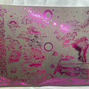 May include: A pink and white map of the Prythian, a fictional land, with the words "The Fae Realm" and "Mortal Lands" printed on it. The map is surrounded by a border of pink floral designs.