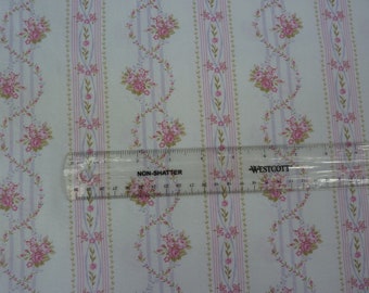 May include: White fabric with a repeating pattern of pink and green floral sprigs and stripes. A ruler is placed on the fabric to show the scale.
