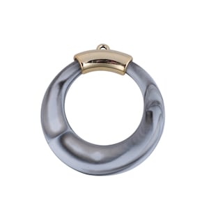 May include: A gray and white marbled ring with a gold metal top. The ring is a pendant or charm.