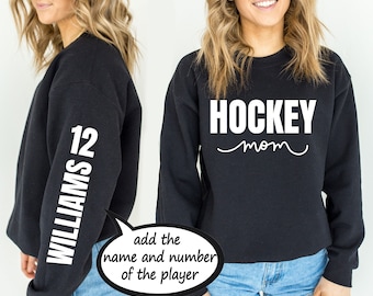May include: Black sweatshirt with the text "HOCKEY mom" on the front and the text "WILLIAMS 12" on the sleeve.