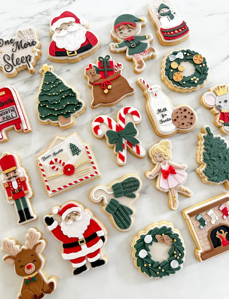 May include: A collection of Christmas-themed cookies, including Santa Claus, elves, reindeer, Christmas trees, wreaths, and a mailbox. Some cookies have text that reads "One More Sleep" and "Milk for Santa". The cookies are decorated with colorful icing.