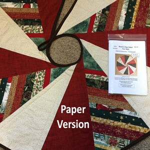 May include: A paper version of a Christmas tree skirt pattern called "Modern Two Sided Tree Skirt" by SEW Artistic, SEW-104. The skirt is made of red, green, white, and gold fabric with a variety of patterns, including stripes, stars, and snowflakes. The pattern includes instructions for sewing and trimming the skirt.